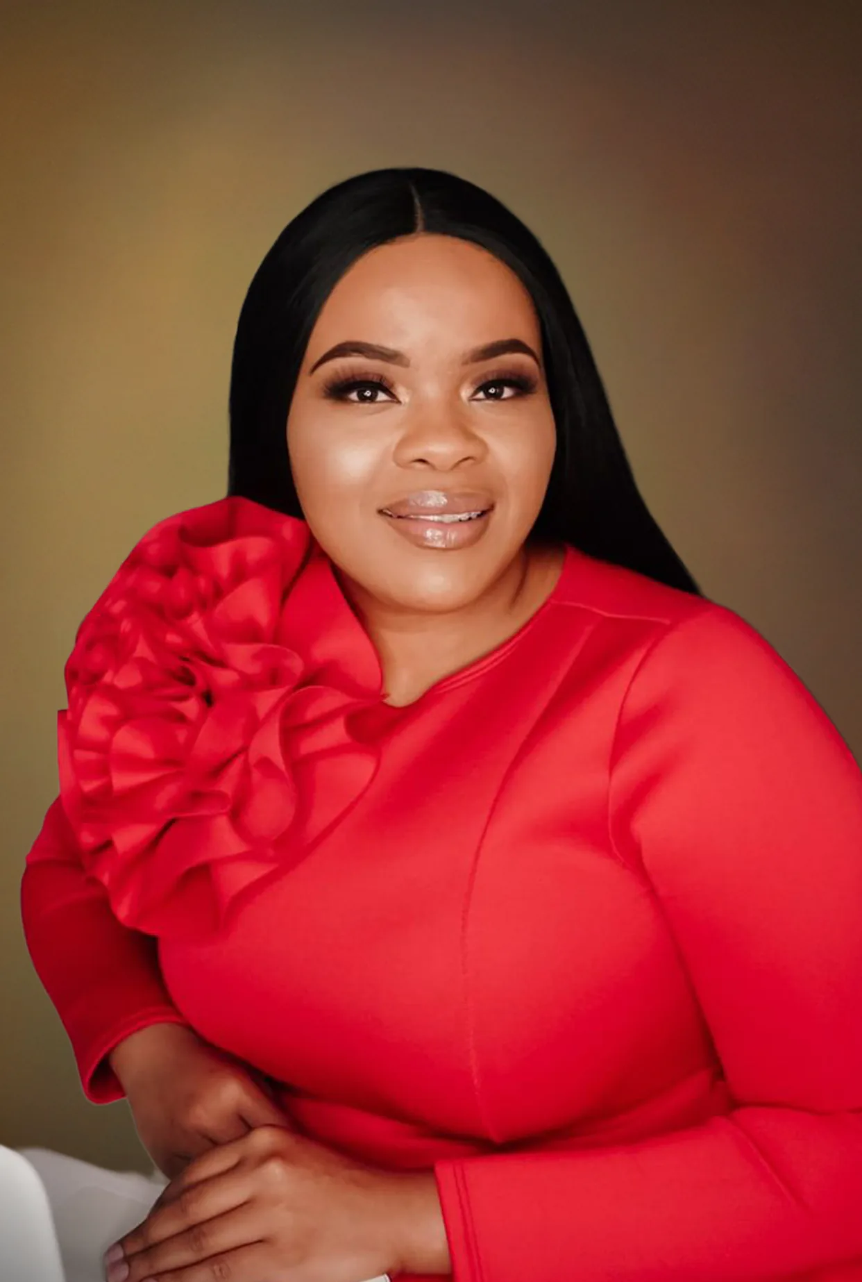 Natacha Alcindor, the founder, smiling in a red dress